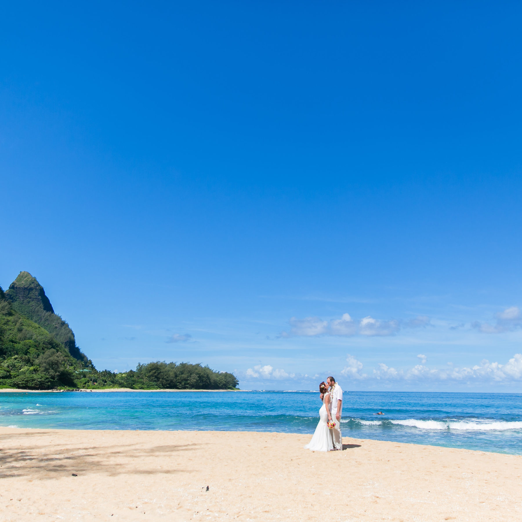 Couple on the beach after morning wedding on Kauai 