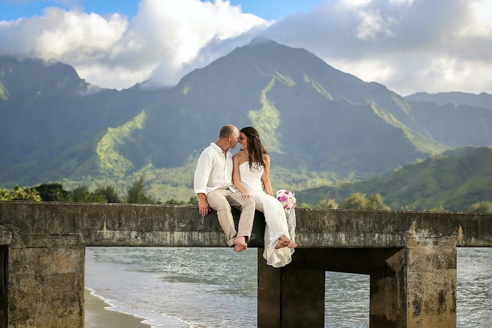 Romantic moment at Hanalei Pier for just married couple